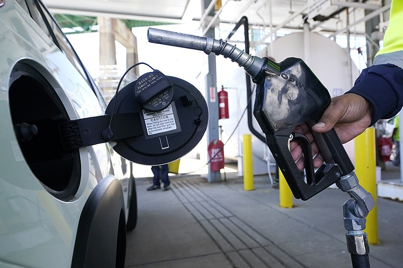 A worker fills up the tank of a new car at the Boston Autoport terminal along the Charlestown waterfront, Tuesday, May 24, 2022, in Boston. (AP Photo/Charles Krupa)