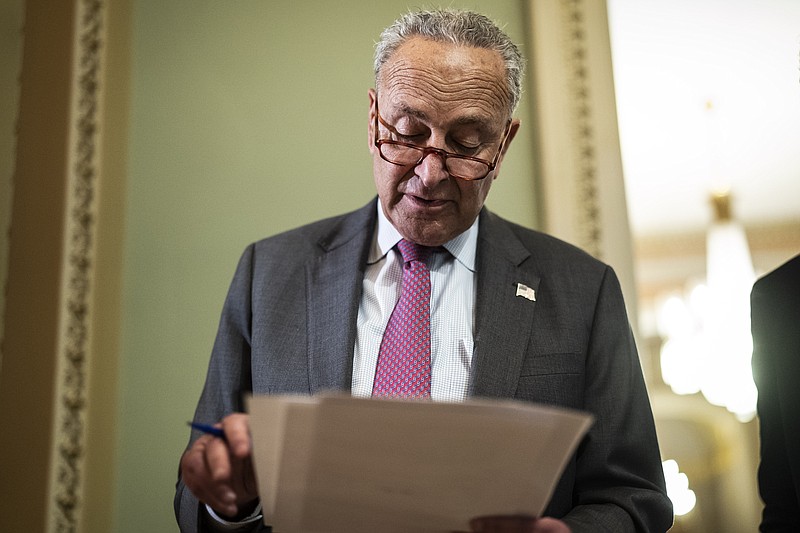 Senate Majority Leader Chuck Schumer, D-N.Y., checks notes at a news conference after a weekly Democratic policy luncheon on Capitol Hill on May 24. (Washington Post photo by Jabin Botsford)