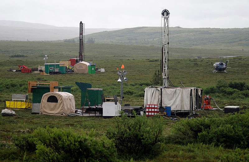 FILE - In this July 13, 2007, photo, workers with the Pebble Mine project test drill in the Bristol Bay region of Alaska, near the village of Iliamma. The U.S. Environmental Protection Agency is proposing restrictions that would hinder plans for a copper and gold mine in Alaska's Bristol Bay region. It is the latest in a long-running dispute over efforts by developers to advance a mine in a region known for its salmon runs. (AP Photo/Al Grillo, File)