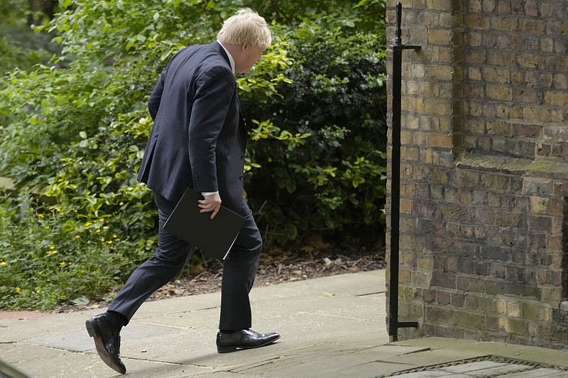 Britain's Prime Minister Bortis Johnson walks in Downing Street to a press conference in London, Wednesday, May 25, 2022. A report into lockdown-breaching U.K. government parties says blame for a "culture" of rule-breaking in Prime Minister Boris Johnson's office must rest with those at the top. Senior civil servant Sue Gray's long-awaited report was published Wednesday.(AP Photo/Kirsty Wigglesworth)