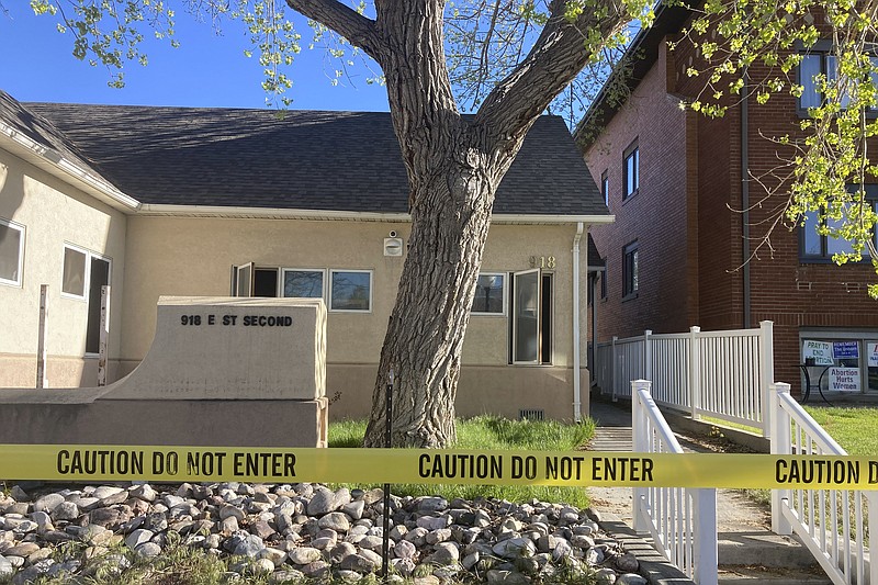 Police tape is placed at the scene of an overnight fire that severely damaged a building that was being renovated to house a new abortion clinic in Casper, Wyoming,  Wednesday, May 25, 2022.  The clinic, which would also provide other health care for women, had been set to open in June. It would become only the second place in the state to offer abortions.  (AP Photo/Mead Gruver)