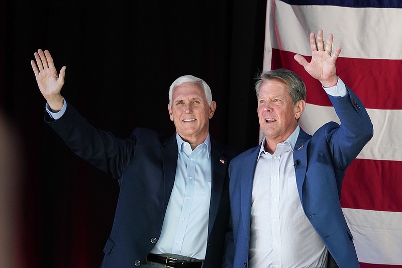 Former Vice President Mike Pence, left, and Georgia Gov. Brian Kemp greet the crowd during a rally, Monday, May 23, 2022, in Kennesaw, Ga. Pence is opposing former President Donald Trump and his preferred Republican candidate for Georgia governor, former U.S. Sen. David Perdue. (AP Photo/Brynn Anderson)