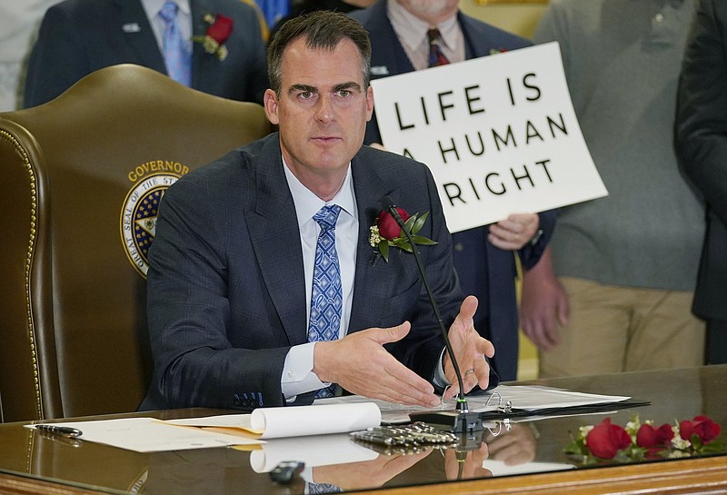 FILE - Oklahoma Gov. Kevin Stitt speaks after signing into law a bill making it a felony to perform an abortion, punishable by up to 10 years in prison, on. April 12, 2022, in Oklahoma City. Stitt on Wednesday, May 25 signed into law the nation’s strictest abortion ban, making the state the first in the nation to effectively end availability of the procedure. State lawmakers approved the ban enforced by civil lawsuits rather than criminal prosecution, similar to a Texas law that was passed last year. (AP Photo/Sue Ogrocki, File)