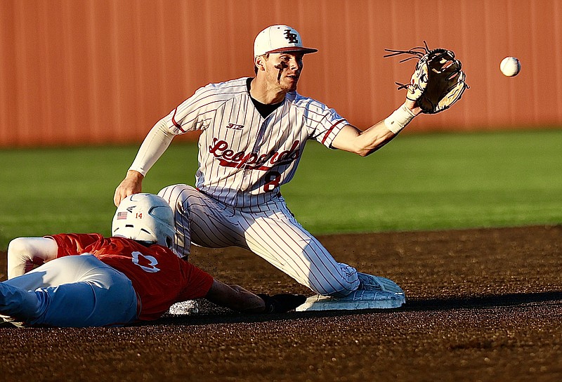 Liberty-Eylau Cal Jones (8) catches the ball as Celina's Major Brignon (8) slides into second base during Thursday night game in Paris, Texas (Photo by JD)