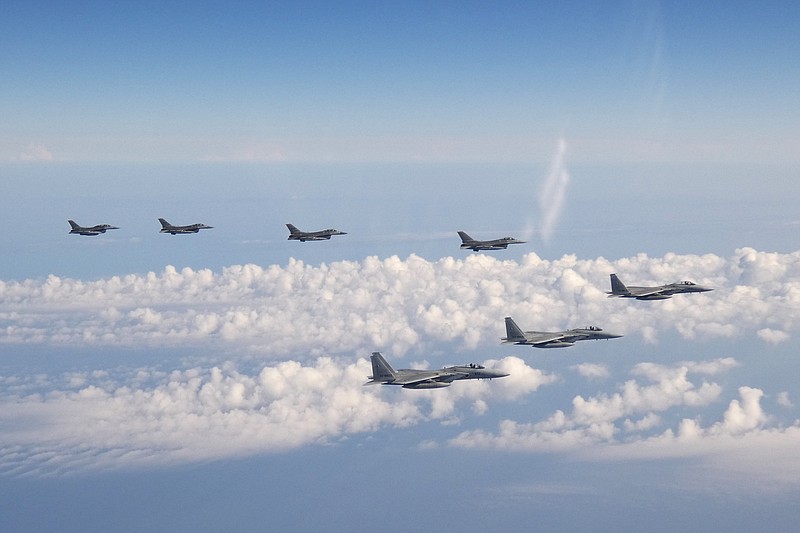 In this photo provided by the Joint Staff of the Japanese Self-Defense Force, three F-15 warplanes of the Japanese Self-Defense Force, front, and four F-16 fighters of the U.S. Armed Forces fly over the Sea of Japan on Wednesday, May 25, 2022. Japanese and U.S. forces conducted the joint fighter jet flight over the Sea of Japan, Japan’s Defense Ministry said Thursday, in an apparent response to a Russia-China joint bomber flight while U.S. President Joe Biden was in Tokyo. (Joint Staff of the Japanese Self-Defense Force via AP)