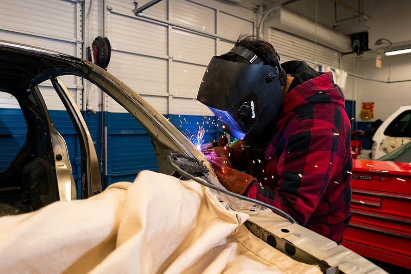 A Texarkana College auto body student welds the frame of a car. (Photo courtesy Texarkana College)