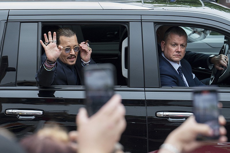 Actor Johnny Depp waves to supporters as he departs the Fairfax County Courthouse Friday, May 27, 2022 in Fairfax, Va.  A jury heard closing arguments in Johnny Depp's high-profile libel lawsuit against ex-wife Amber Heard. Lawyers for Johnny Depp and Amber Heard made their closing arguments to a Virginia jury in Depp's civil suit against his ex-wife.(AP Photo/Craig Hudson)