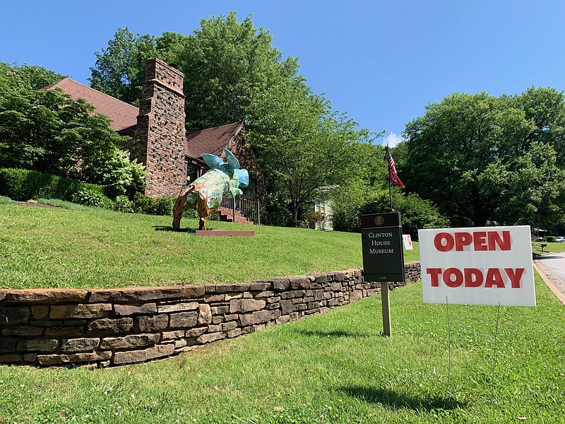 A sign advertising that the museum is open stands Friday, May 27, 2022, outside the Clinton House Museum in Fayetteville. The museum closed in 2020 during the covid-19 pandemic and has reopened 10 a.m. to 4 p.m. on Thursdays, Fridays and Saturdays with the intention of resuming daily operation. Visit nwaonline.com/220528Daily/ for today's photo gallery. 
(NWA Democrat-Gazette/Andy Shupe)