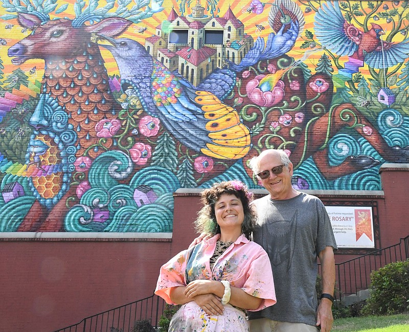 Artist Danaé Brissonnet and building owner Bob Graham stand in front of the finished mural at 110 Central Ave. - Photo by Tanner Newton of The Sentinel-Record