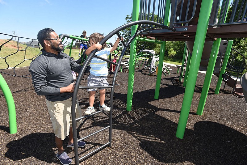 Thomas Ubben of Rogers and his son, Hayden, 2, play on Friday May 27 2022 at Shaw Family Park in Springdale.
(NWA Democrat-Gazette/Flip Putthoff)