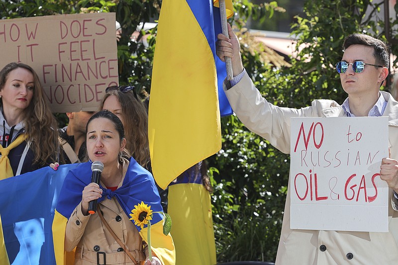 Ukrainian demonstrators demand an embargo on Russian oil during a protest in front of EU institutions prior to an extraordinary meeting of EU leaders to discuss Ukraine, energy and food security at the Europa building in Brussels, Monday, May 30, 2022. European Union leaders will gather Monday in a fresh show of solidarity with Ukraine but divisions over whether to target Russian oil in a new series of sanctions are exposing the limits of how far the bloc can go to help the war-torn country. (AP Photo/Olivier Matthys)