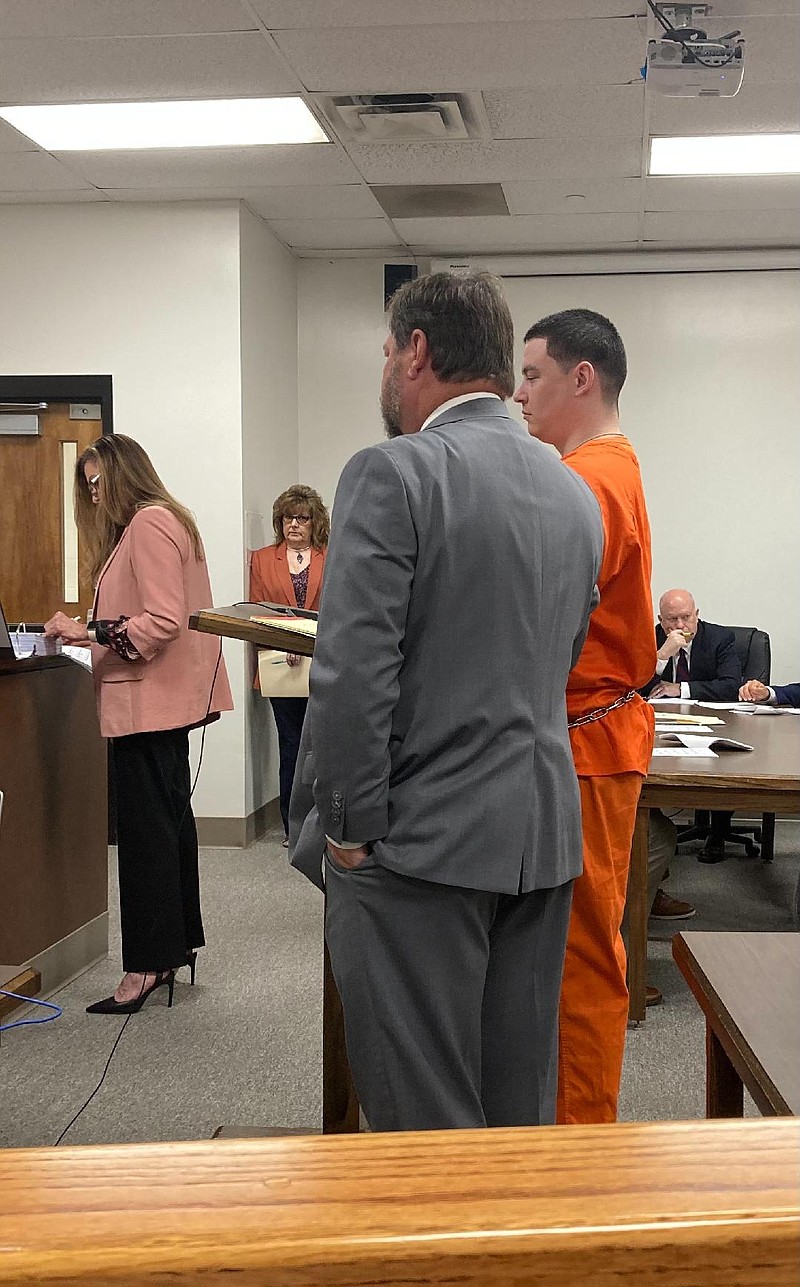 Everette Cawley, in orange, stands with Texarkana lawyer Jeff Harrelson before Miller County Circuit Judge Brent Haltom for a plea hearing Tuesday morning. Cawley was sentenced to a 46-year term in the 2019 death of his 3-year-old daughter. (Staff photo by Lynn LaRowe)