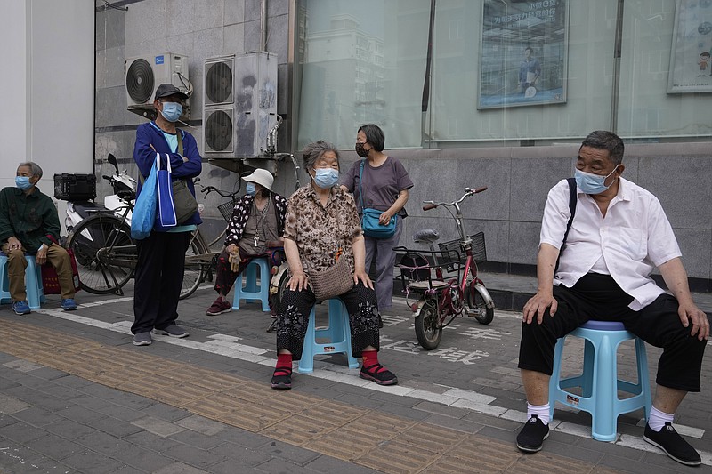 Elderly residents wait in line to collect their pension as banking services reopen after pandemic measure lockdown are lifted, Tuesday, May 31, 2022, in Beijing. (AP Photo/Ng Han Guan)