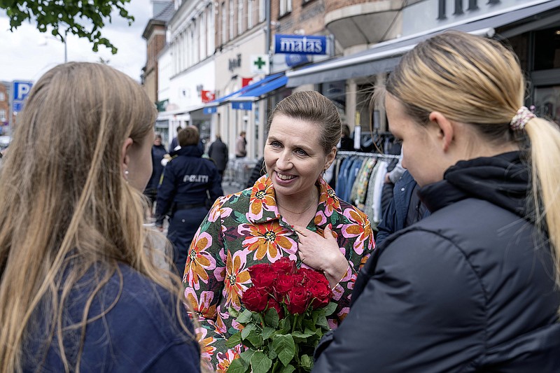 FILE - Denmark's Prime Minister Mette Frederiksen, center, speaks to people while on an election campaign, in Holbaek, Denmark, Saturday, May 28, 2022. Voters on Wednesday will decide whether to abandon their country's 30-year-old opt-out from the bloc's common defense policy. (Claus Bech/ Ritzau Scanpix via AP, File)