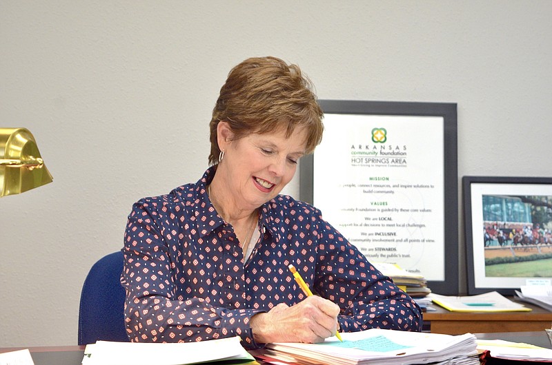 Joyce Whitfield, executive director of the Hot Springs Area Community Foundation, works at her desk on Tuesday. - Photo by Donald Cross of The Sentinel-Record