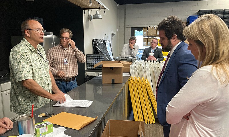 Candidate Jody Harris and her campaign’s attorney, Clint Lancaster of Benton look on as election commission chairman Bill Coleman opens the original absentee ballots in the District 25 race. (NWA Democrat-Gazette/DOUG THOMPSON)