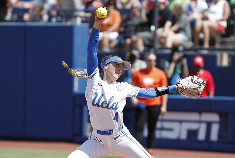 UCLA's Holly Azevedo (4) pitches in the fifth inning of an NCAA softball Women's College World Series game against Florida on Sunday, June 5, 2022, in Oklahoma City. (AP Photo/Alonzo Adams)