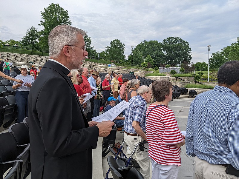 Jeremy Secrist, pastor at St. Peter Catholic Church, sings "Amazing Grace" with people from various area churches Sunday evening, June 5, 2022, during the Community Pentecost Celebration at Capital Region MU Health Care Amphitheater. The Christian holiday is celebrated 50 days after Easter to commemorate the gift of the Holy Spirit. (Ryan Pivoney/News Tribune photo)