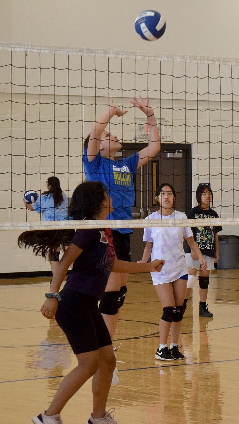 Westside Eagle Observer/MIKE ECKELS
Jenecis Batres (upper center) spikes the ball over the net past some of her teammates playing on the other side of the court during the second day of volleyball practice at the Decatur Middle School gym June 7. Twenty middle school students from first timers to experienced players took the court to learn more about the sport or simply hone their skills.