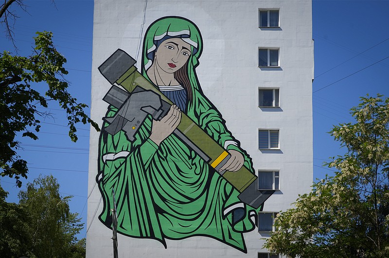 A mural depicts an image known as &quot;Saint Javelina&quot;- Virgin Mary cradling a US-made FGM-148 anti-tank weapon Javelin - on a living house wall in Kyiv, Ukraine, Monday, June 6, 2022. These missiles are among the arms being sent by Western allies to Ukrainian forces to aid in their fight against the Russian invaders. Javelin is widely considered a symbol of Ukraine's defence.(AP Photo/Efrem Lukatsky)