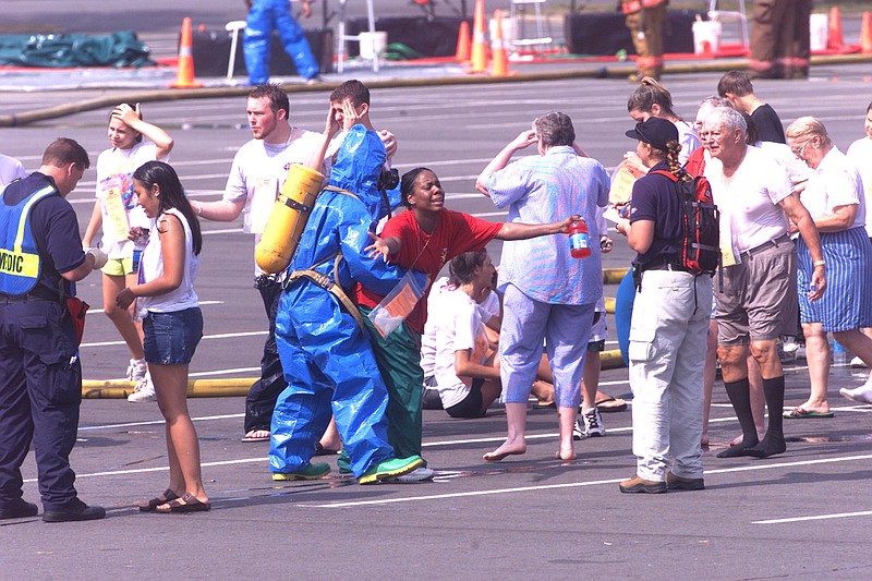 Emergency personnel pretend to treat actors playing contaminated victims June 12, 2002, during a drill simulating the release of a weapon of mass destruction at War Memorial Stadium in Little Rock. 
(Democrat-Gazette file photo/Staton Breidenthal)