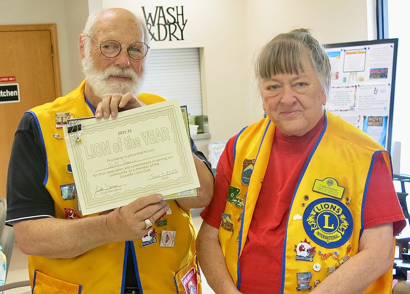 Westside Eagle Observer/SUSAN HOLLAND
Jeff Davis displays the certificate and pin he received honoring him as 2021-2022 Lion of the Year for his "dedication and commitment in serving our community as a member of the Gravette Lions Club." Davis poses with club president Linda Damron, who presented him the award. Davis, who has been serving as club treasurer, was installed as 2022-2023 president at the meeting.