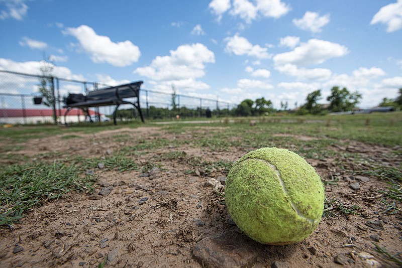 A tennis ball is seen on Thursday, June 9, 2022, at the Chaffee Crossing dog park in Fort Smith. The site was one of two in Fort Smith, along with the Riverfront Skate and Bike Park, selected by the National Fitness Campaign to receive artistic outdoor fitness courts, a partnership with which the city directors unanimously agreed to help them get installed. Visit nwaonline.com/220612Daily/ for today's photo gallery.
(NWA Democrat-Gazette/Hank Layton)