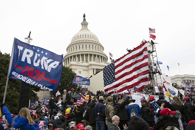 Supporters of President Donald Trump stand outside the U.S. Capitol in Washington on Jan. 6, 2021. The public hearings of the House committee investigating the insurrection pose a challenge to Democrats seeking to maintain narrow control of Congress. (AP Photo/Jose Luis Magana, File)