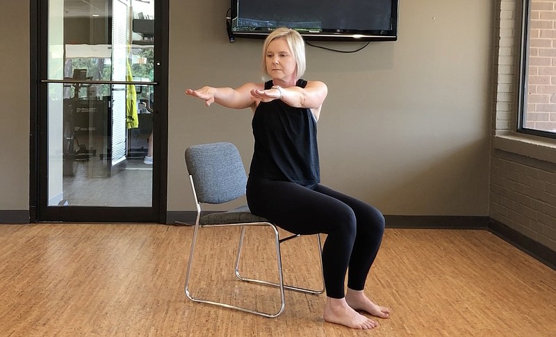 Registered yoga teacher Natalie Staley demonstrates the Office Chair Torso Twist at Little Rock Racquet Club.
(Arkansas Democrat-Gazette/Celia Storey)