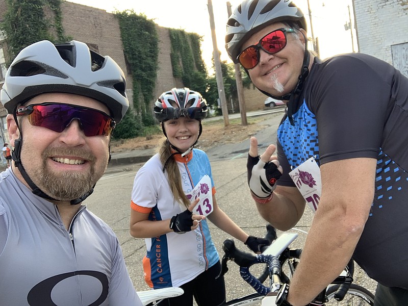 Fred Mitchell, left, stands with his daughter Brodie Mitchell and his friend Rustin Baber at the end of last year’s Pedals for Compassion Ride in Magnolia. Submitted photo