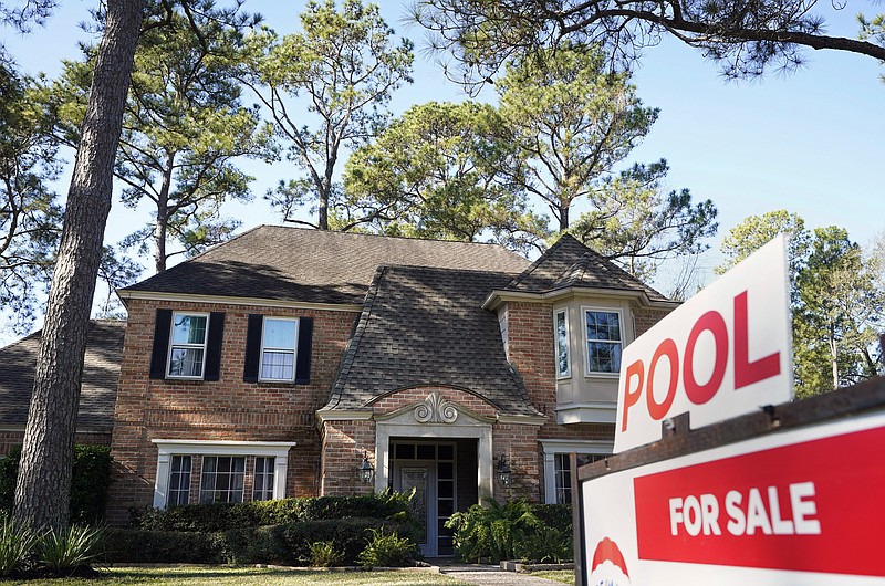 FILE - In this Wednesday, Jan. 13, 2021, file photo, a real estate sign is shown at a home for sale, in Houston. The red-hot U.S. housing market is paying off for many homeowners, even those who aren’t looking to sell their home. Real estate information company CoreLogic says, on average, homes with a mortgage gained $26,300 in equity over the last three months of 2020 versus a year earlier. (Melissa Phillip/Houston Chronicle via AP, File)