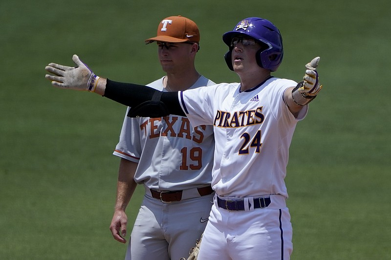 East Carolina's Ben Newton celebrates after a double as Texas infielder Mitchell Daly looks on during the fourth inning of an NCAA college super regional baseball game Friday, June 10, 2022, in Greenville, N.C. (AP Photo/Chris Carlson)