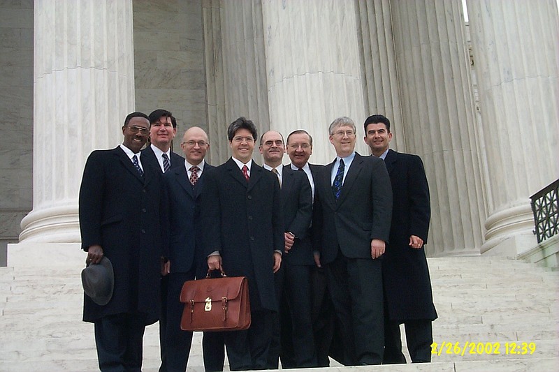 Members of the legal team defending Jehovah's Witnesses pose for a photo on the steps of the U.S. Supreme Court building in February 2002. Less than four months later, the court delivered an 8-1 decision striking down a law that required Witnesses to register with an Ohio township before going door-to-door there. (File photo)