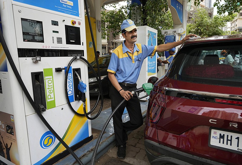 An employee of a Bharat petroleum fuel station fills petrol in a vehicle in Mumbai, India, Saturday, June 11, 2022. India and other Asian nations are becoming an increasingly vital source of oil revenues for Moscow as the U.S. and other Western countries cut their energy imports from Russia in line with sanctions over its war on Ukraine. (AP Photo/)
