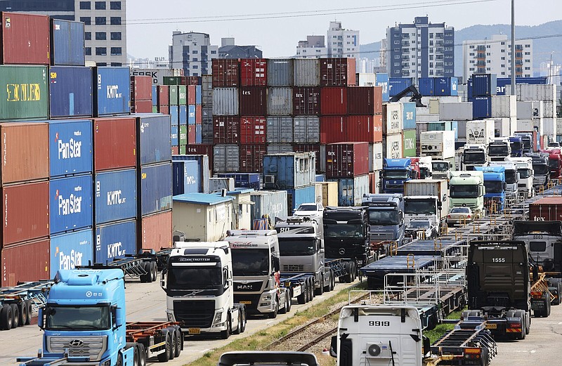 Trucks are parked next to containers at the Inland Container Depot in Uiwang, South Korea, Monday, June 13, 2022. A weeklong strike by thousands of truckers in South Korea has triggered major disruptions in cargo transport and production that have caused 1.6 trillion won ($1.2 billion) in damages, officials said Monday. (Hong Ki-won/Yonhap via AP)