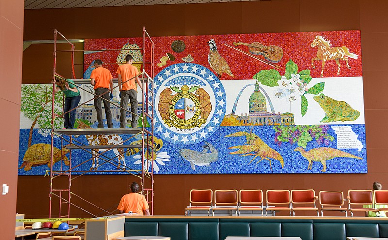 A crew contracted to perform the installation of Missouri's Bicentennial Mural worked in mid May to get the panels put together to form the large painting that will hang in the Harry S Truman State Office Building cafeteria in Jefferson City. (Julie Smith/News Tribune photo)