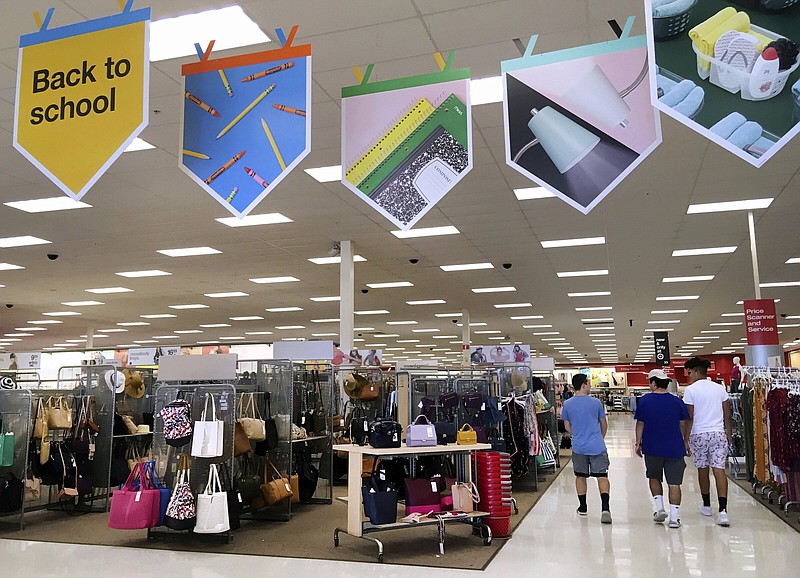 FILE - Shoppers walk into a store in Methuen, Mass., July 31, 2018. The 2022 back-to-school shopping season should enjoy strong sales increases from a year earlier, fueled by heavy demand for trendy fashion, though the growth won’t be as robust as in 2021 when business was rebounding from pandemic-related virtual schooling. (AP Photo/Elise Amendola, File)