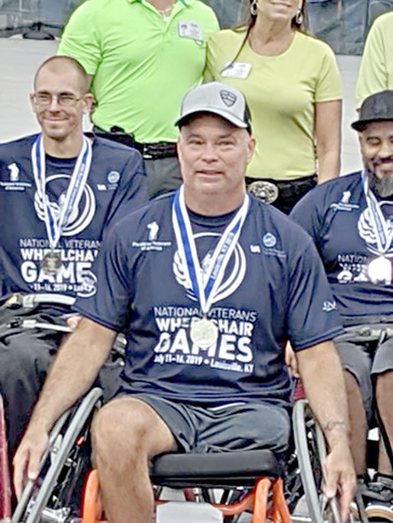 Photo submitted Jason Long has his photo taken with some of his basketball team members at the 2019 National Veterans Wheelchair Games. After two years off, Long plans to compete again this year in early July.