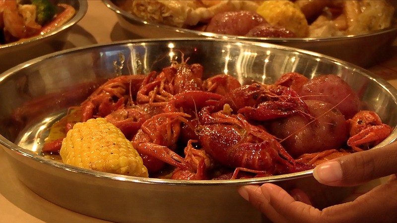 A dish of boiled crawfish with potatoes and corn is shown. - Photo by Andrew Mobley of The Sentinel-Record