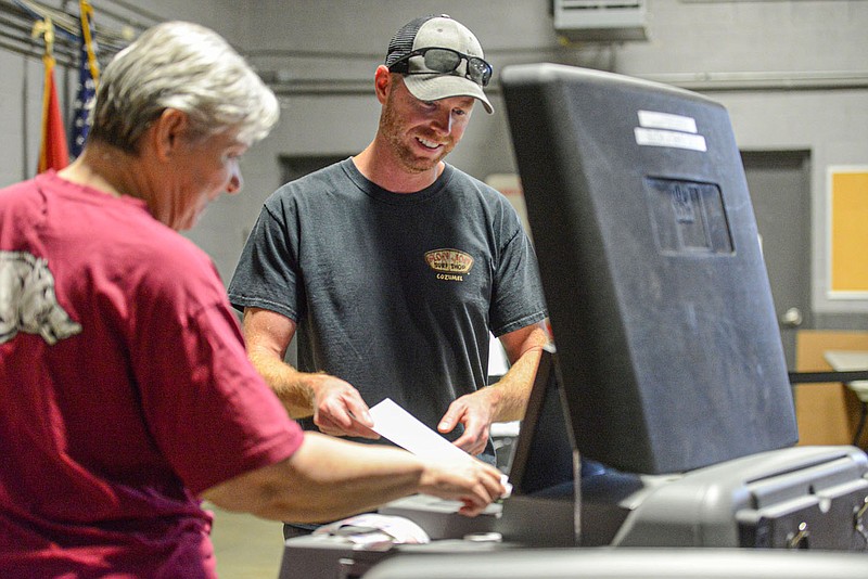 Travis Brown casts his ballot with the help of Cathy Rogers, a poll worker, on Friday, June 17, 2022, as part of early voting at the Van Buren Emergency Operations Center in Van Buren. Voters in Crawford County, which in addition to Van Buren includes Alma, Cedarville, Dyer, Mountainburg, Mulberry and Rudy, will finish voting for county clerk, county judge and county sheriff on Election Day Tuesday. Visit nwaonline.com/220618Daily/ for today's photo gallery.
(NWA Democrat-Gazette/Hank Layton)