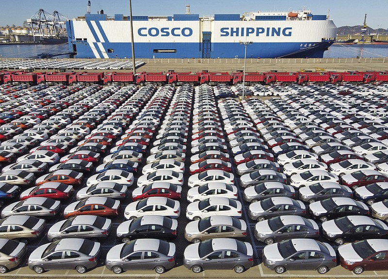 In this photo released by Xinhua News Agency, an aerial view shows manufactured vehicles before being loaded onto a cargo ship at the Yantai Port in eastern China's Shandong Province, Dec. 7, 2021. China's trade growth rebounded in May 2022 after anti-virus restrictions that shut down Shanghai and other industrial centers began to ease. (Tang Ke/Xinhua via AP)