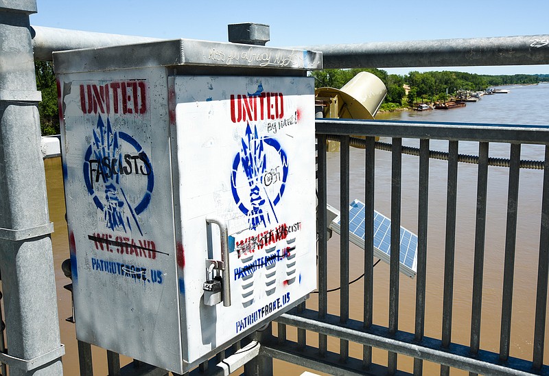 Vandalism occurred over the weekend on the power box on the Pat Jones Pedestrian Bridge over the Missouri River at Jefferson City, promoting the group Patriot Force. Using markers, others wrote over the paint, calling the group fascists and referencing patriotfarce.us. (Julie Smith/News Tribune photo)