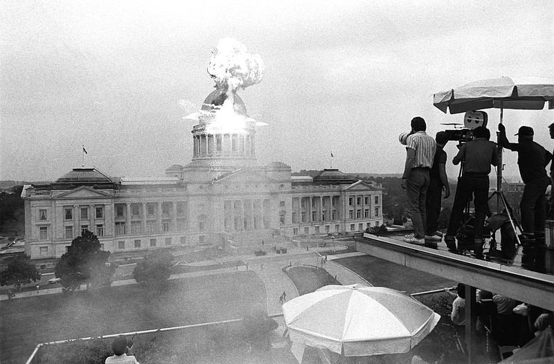 A crew filming the made-for-TV movie "Under Siege" records a fake missile strike on the Arkansas Capitol about 6 p.m. Oct. 17, 1985. The "missile" was fired from the National Old Line Building on a wire stretched between the buildings. (Democrat-Gazette archives)