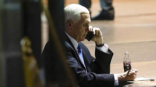 In this image from video released by the House Select Committee, Vice President Mike Pence talks on a phone from his secure evacuation location during the attack on the Capitol on Wednesday, Jan. 6, 2021. The video was displayed Thursday, June 16, 2022, during a hearing by the House select committee investigating the attack. (House Select Committee via AP)