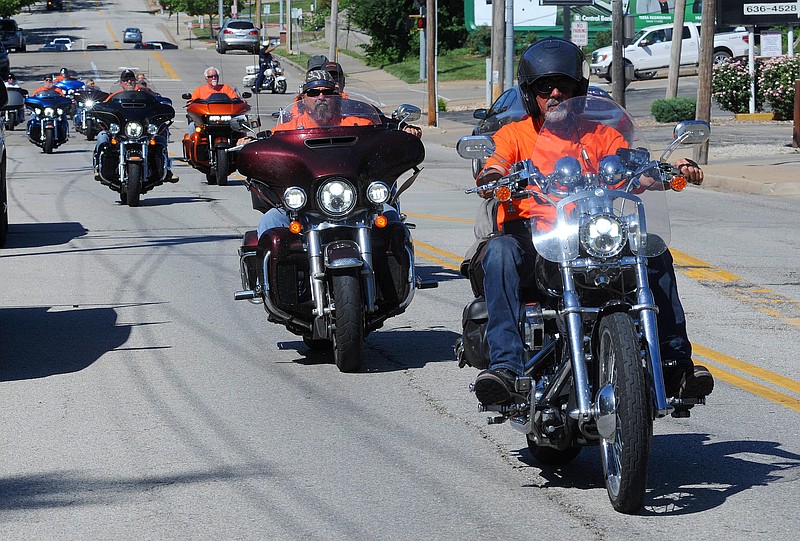 Dozens of motorcycles and their volunteer riders crossed through Jefferson City with a Police escort as they arrived to work at the Building Community Bridges building on Ashley Street. Shaun Zimmerman / News Tribune