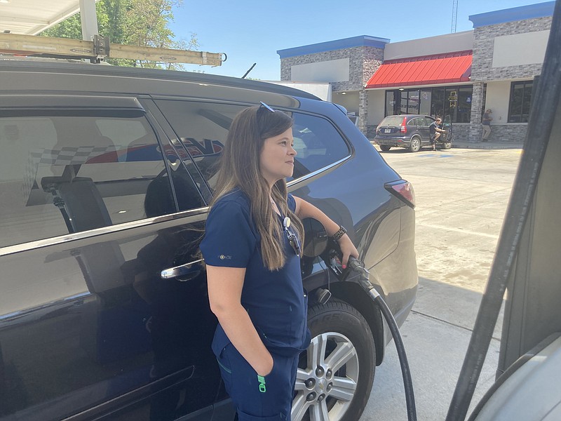 Carla Solano watches as the price of the gas she's buying on Monday comes to a stop at $89. In normal times, she said, her family is able to travel more but not now with the high price of fuel. (Pine Bluff Commercial/Byron Tate)