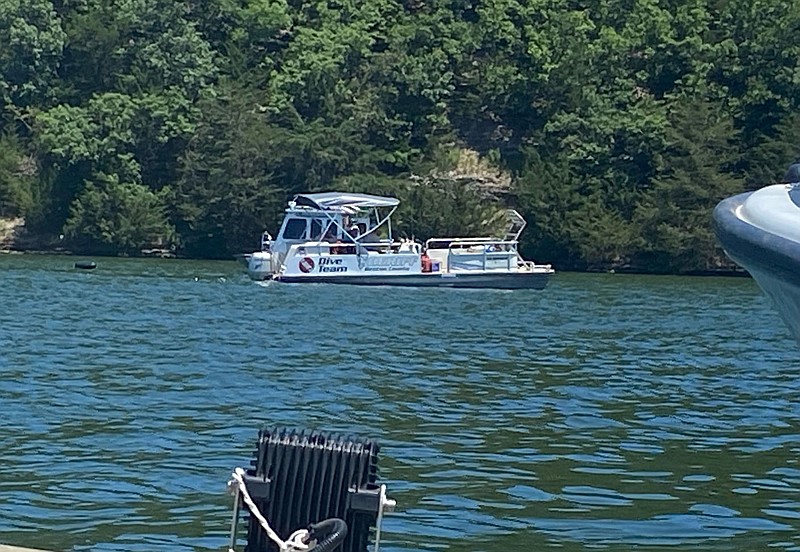A Benton County Sheriff's Office dive team boat searches Beaver Lake on Monday, June 20, 2022, for a man who went missing two days earlier.