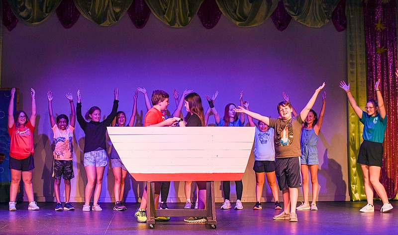 As Prince Eric, played by Taylor Miller and Ariel, played by Natalie Wilson, take their place in the boat, the rest of the cast dance and sing around them as they rehearse for the upcoming production of The Little Mermaid at Capital City Productions. (Julie Smith/News Tribune photo)