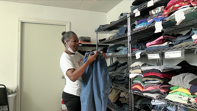 A St. Luke's Episcopal Church volunteer finds clothes for the homeless during the church's weekly Tuesday shower ministry. - Photo by Andrew Mobley of The Sentinel-Record