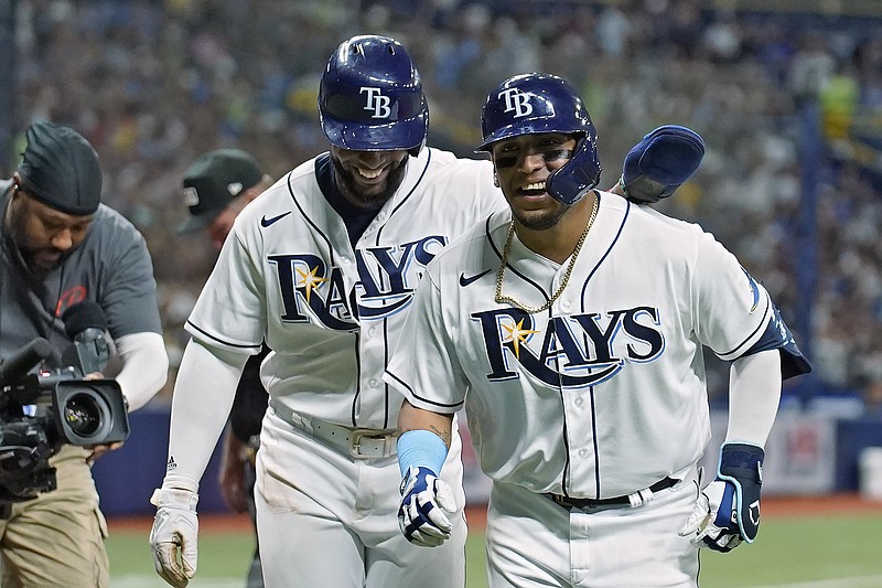 Tampa Bay Rays' Isaac Paredes, right, celebrates with Yandy Diaz after Paredes hit a two-run home run off New York Yankees pitcher Clarke Schmidt during the fifth inning of a baseball game Tuesday, June 21, 2022, in St. Petersburg, Fla. (AP Photo/Chris O'Meara)
